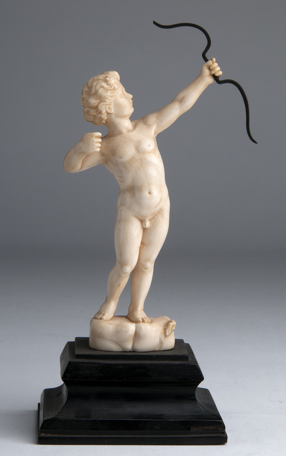 “Cupid”. A carved ivory figure depicting Cupid while shooting an arrow - France, 19th Century; ;