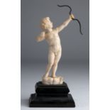 “Cupid”. A carved ivory figure depicting Cupid while shooting an arrow - France, 19th Century; ;