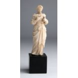 A carved ivory figure of a lady - England, 19th Century; ; 15.7 cm, 6 3/16 in high overall, base 4.2