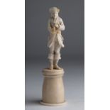 A carved ivory figure of musician - probably England, 19th Century; ; on ivory base. 16 cm, 6 19/