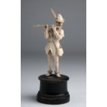 "The Pied Piper of Hamelin". A carved ivory figure - probably Germany, 19th Century; ; on a wooden