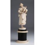 A carved ivory figure of a beggar - Germany / Holland, 19th Century; ; on a wood and ivory base.