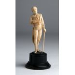 A carved ivory figure of a gentleman - England, late 19th Century; ; on a wooden base. 13.5 cm, 5