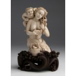 A carved ivory figural group depicting a young lady with a Satyr - P. Wood, Japan, late 19th / early