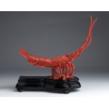 A carved coral sculpture depicting a Lobster - China, 20th Century(pre-1947);on a wooden base