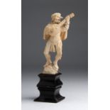 A carved ivory figure of a Minstrel - Naples, 18th / 19th Century; ; on a wooden base. 20 cm, 7 7/