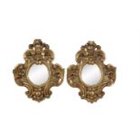 A PAIR OF ITALIAN GILT WOOD WALL MIRRORS of cartouche form with oval mirror plates, 53 x 41cm