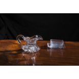 A 19TH CENTURY CUT GLASS JUG, the wide spout and c-scroll handle set into a shallow heavy star-cut