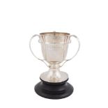 AN EDWARDIAN SILVER THREE HANDLE TROPHY CUP, London 1904, maker's mark of Josiah Williams & Co.,