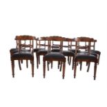 A SET OF TWELVE GEORGE IV MAHOGANY FRAMED DINING CHAIRS, the curved rail back with foliate scroll