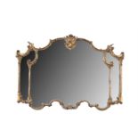 A 19TH CENTURY CARVED GILTWOOD COMPARTMENTED OVERMANTLE MIRROR, of shaped rectangular form, the