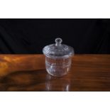 A 19TH CENTURY CUT GLASS BISCUIT BARREL AND COVER, of circular form with domed lid and facetted