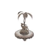 A NATURALISTIC SILVER PLATED CENTREPIECE DEPICTING A STAG BY TWO ENTWINED PALM TREES, probably by