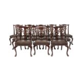 A SET OF TWELVE GEORGE III STYLE MAHOGANY FRAMED DINING CHAIRS, the moulded rims with undulating