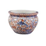 A LARGE JAPANESE IMARI BOWL, 19th century, decorated in blues and rusts, with birds and foliage on a