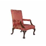 A GEORGE III MAHOGANY GAINSBOROUGH ARMCHAIR, the back and splat upholstered in red patterned damask,