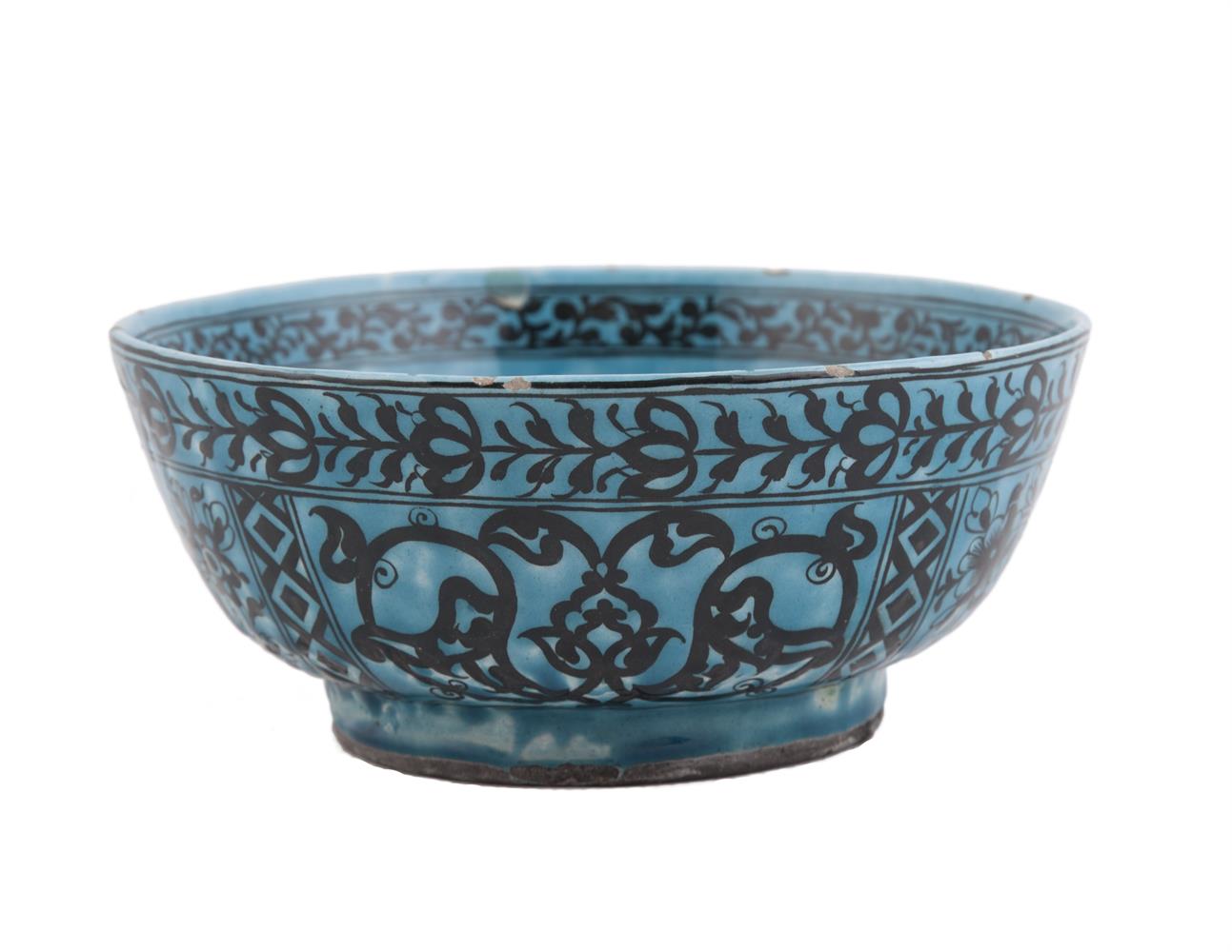 AN ISLAMIC BLUE GLAZED BOWL, probably Persian, of deep circular form, the exterior inked with four