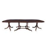 A REGENCY MAHOGANY CUMBERLAND-ACTION DINING TABLE, the centre double drop leaf section with