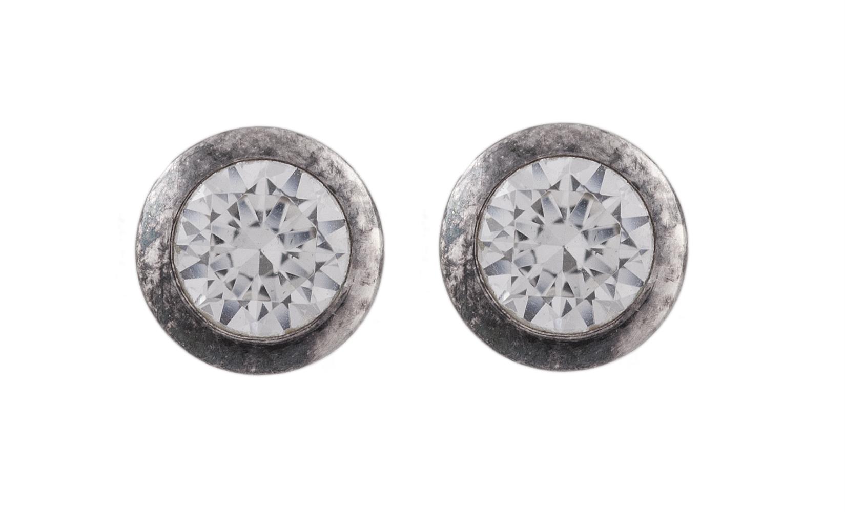 A PAIR OF EAR STUDSEach colourless round shaped stones, mounted in silver