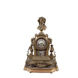 A FRENCH ORMOLU AND PORCELAIN MOUNTED MANTEL CLOCK, surmounted by a female portrait bust. 46.5 x