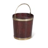 AN IRISH GEORGE III MAHOGANY BRASS BOUND BUCKET, of coopered construction, with brass swing