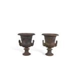 A PAIR OF CAST IRON CAMPAGNA SHAPED URNS, with lobed rims, foliate banded bodies, twin handles and