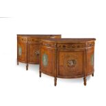 A PAIR OF GEORGE III STYLE PAINTED SATINWOOD DEMI LUNE COMMODES, the tops decorated with painted