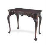 AN IRISH GEORGE III MAHOGANY SHAPED RECTANGULAR FOLDING TOP CARD TABLE, c.1750, the baize lined