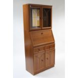 A teak-finish bureau bookcase fitted plate glass shelf to top enclosed by pair of bevelled glazed