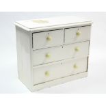 A Victorian white painted pine dwarf chest fitted two short & two long graduated drawers with turned