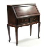A Chinese hardwood bureau with fitted interior enclosed by fall-front, above two small drawers, & on
