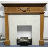 A pine fire surround with carved floral appliqué & fluted frieze, & fluted supports, 50” wide x 46¾"