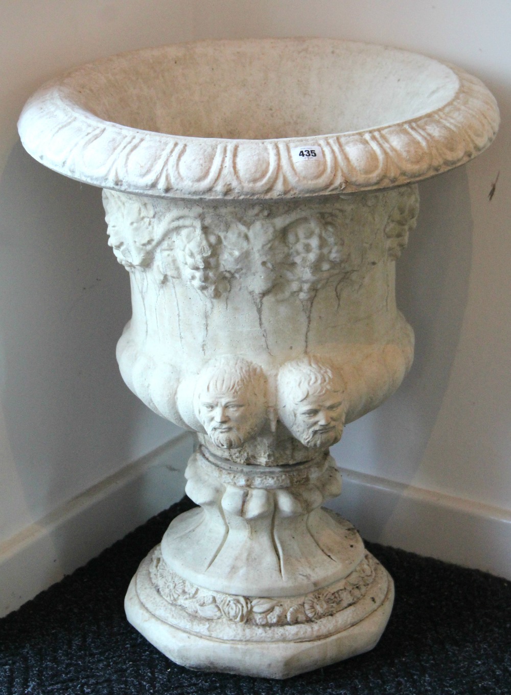A cast reconstituted stone campana-shaped garden urn, 21" diam. x 27" high.
