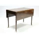 A regency mahogany Pembroke table fitted end drawer, on ring-turned tapered legs with ceramic