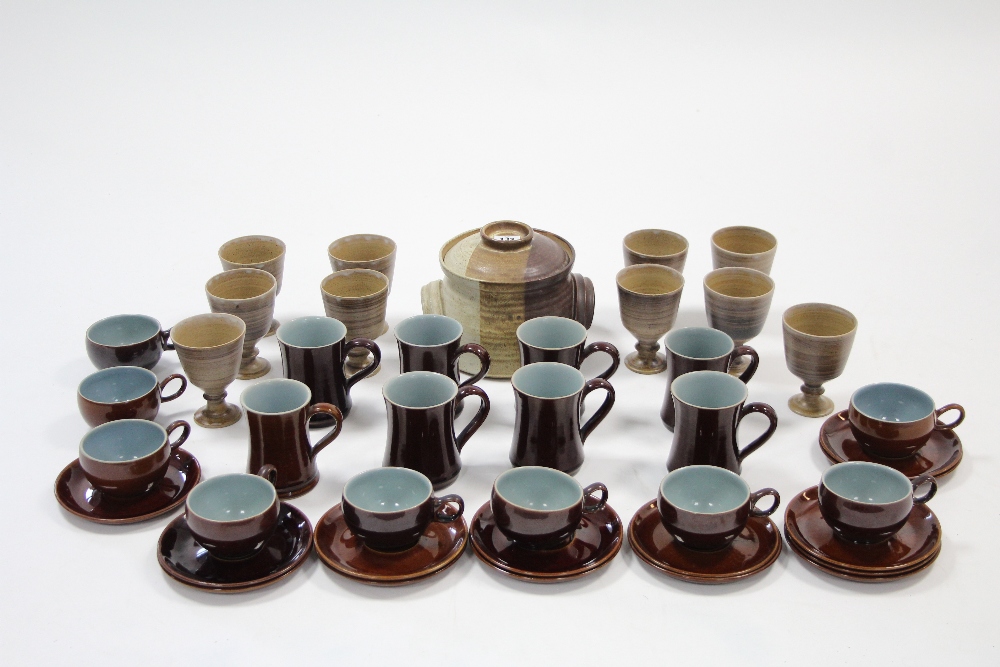 A set of eight Denby treacle glazed coffee mugs; nine ditto coffee cups; fourteen ditto saucers; a