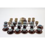 A set of eight Denby treacle glazed coffee mugs; nine ditto coffee cups; fourteen ditto saucers; a