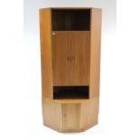 A Beithcraft of Scotland teak tall standing corner cabinet, the upper part enclosed by panel door to