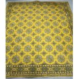 A Persian pattern carpet of mustard ground & with all-over repeating multi-coloured geometric