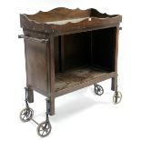 An oak tray-top dinner wagon with open recess to front, & on short square legs with spoke wheels,