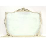 An overmantel mirror with rounded lower part, in carved & pierced white painted frame, 70”.