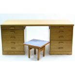 A light oak pedestal desk with rectangular top, fitted five long graduated drawers to the right-hand