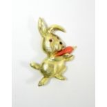 A CARTIER 18ct. GOLD NOVELTY RABBIT BROOCH inset ruby eyes, black onyx nose, & holding a coral