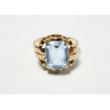 An Austrian gold (585) ring set rectangular aquamarine to an open scroll mount.