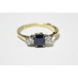 An 18ct. gold ring set rectangular sapphire, a diamond either side.