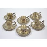 Six Sterling pierced cylindrical cup-holders with saucer stands. (14½oz).