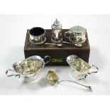 A three-piece condiment set with matching mustard spoons, Birmingham 1926, in fitted case; a small