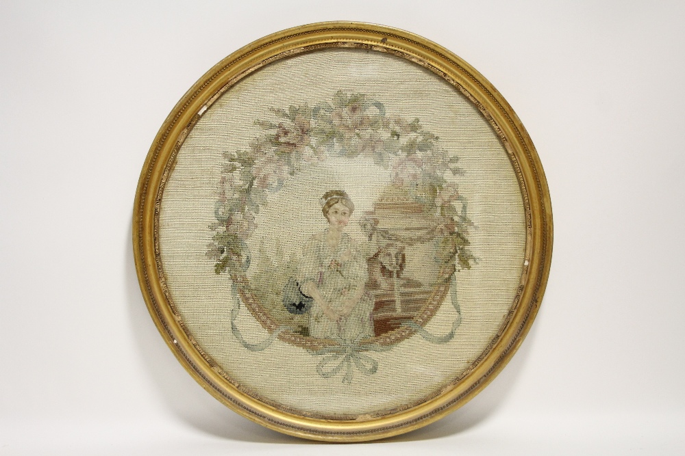A late 18th/early 19th century gros-point & petit-point needlework picture of a young woman beside a