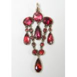 A 19th century gold articulated pendant set seventeen foil-backed garnets of mixed cut.