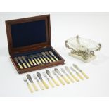 Twelve pairs of late Victorian engraved fish eaters, in fitted mahogany case; & a centrepiece with