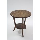 An oriental carved hardwood circular two-tier occasional table with dragon decoration, & on three